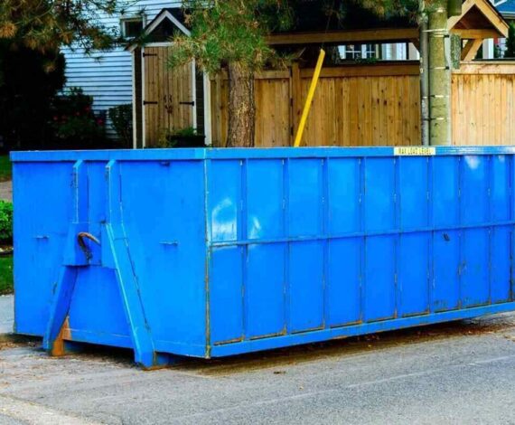 blue roll-off construction dumpster rental outside a seasonal property