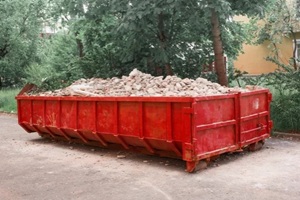construction waste in a red dumpster