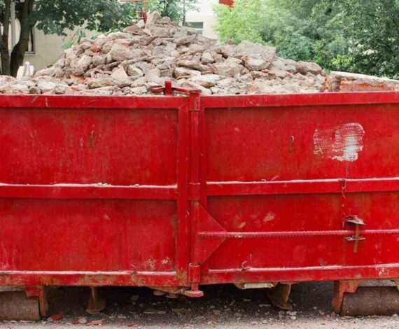 red container with solid domestic and construction waste