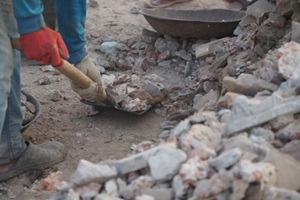 construction workers clearing debris from a building site
