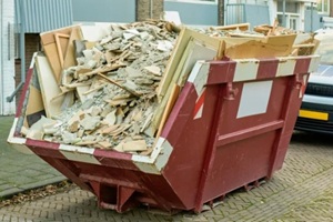 red dumpster carrying construction waste
