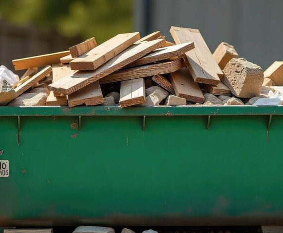 green dumpster overflowing with wooden construction waste outdoors