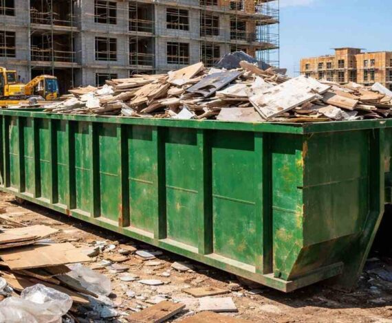 green dumpster in a construction site