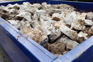 big dumpster with big stones
