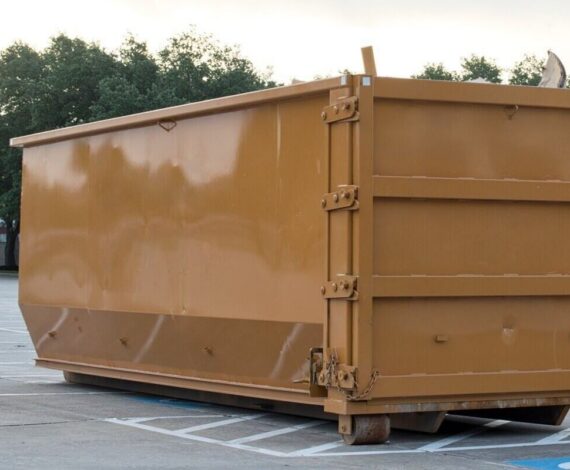 dumpster rental industrial bin in commercial parking lot site brown trash removal skip