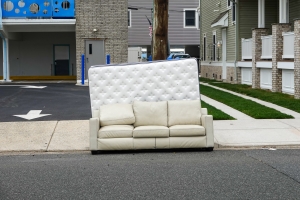 Discarded Mattress and Couch on the Curb Waiting for Trash Pickup