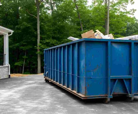 Large Blue Dumpster Rental Outside a Modern House