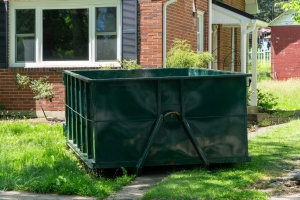 Large Green Roll-Off Dumpster Rental Placed on a Lush Residential Lawn