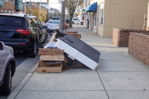 Old Mattress and Broken Wooden Furniture on Sidewalk for Bulk Trash Pickup