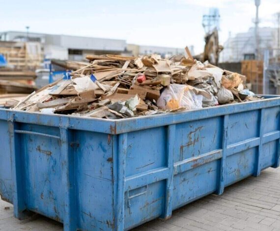 industrial dumpster with construction waste under bright sky, minimalist composition