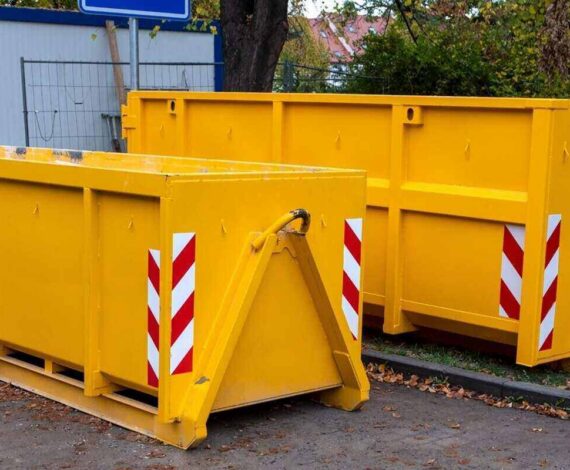two yellow metal dumpster containers for construction garbage, house renovation