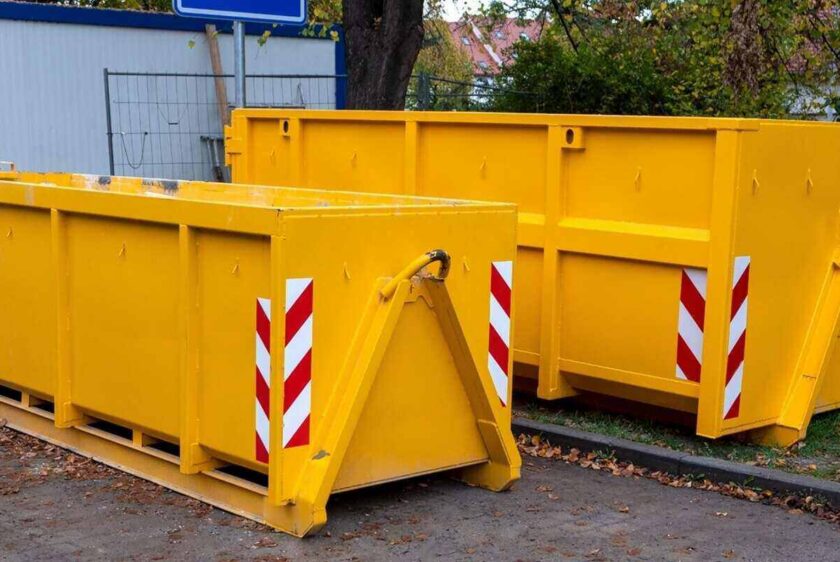 two yellow metal dumpster containers for construction garbage, house renovation