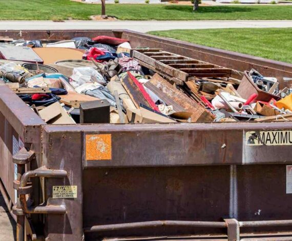 waste dumpster full of household junk