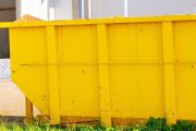 construction site with metal container dumpsters for storing waste during construction