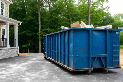 Large Blue Dumpster Rental Outside a Modern House