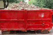 red container with solid domestic and construction waste
