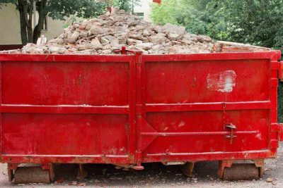 red container with solid domestic and construction waste