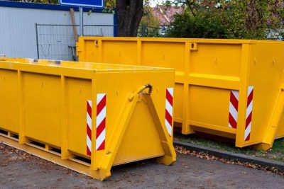 two yellow metal dumpster containers for construction garbage, house renovation