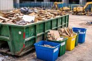 various size dumpsters near a construction building