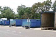 various size dumpsters parked near the road