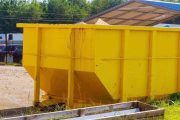 waste is stored in metal containers in dumpsters